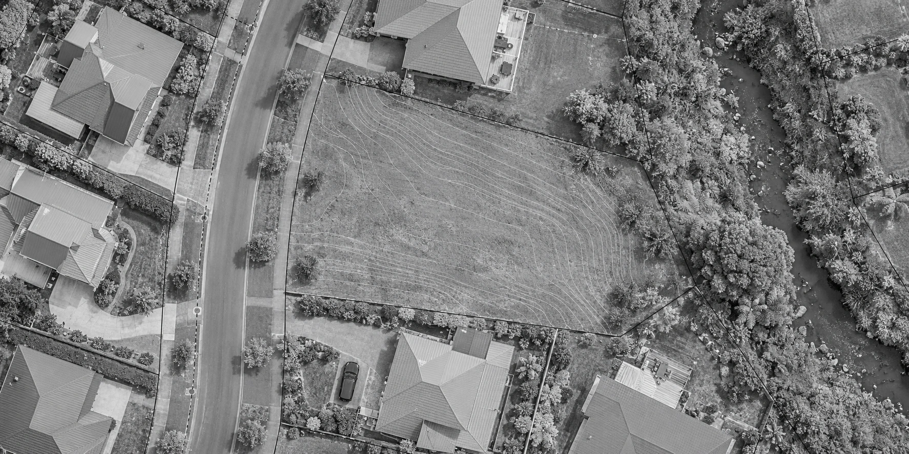 Overhead residential site imagery with property boundaries, contours and a service route